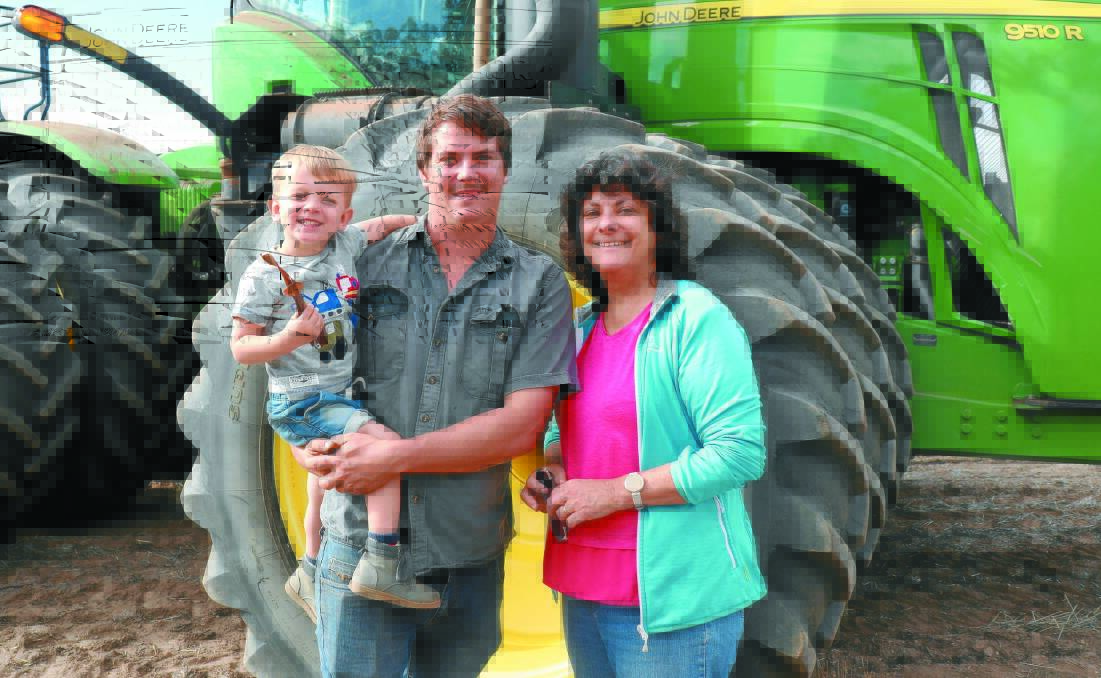 Reuben Woods (centre) helps to run the cropping program alongside his father and brother-in-law, while Suzanne Woods (right) looks after the books and Fletcher (left) keeps everyone on their toes.