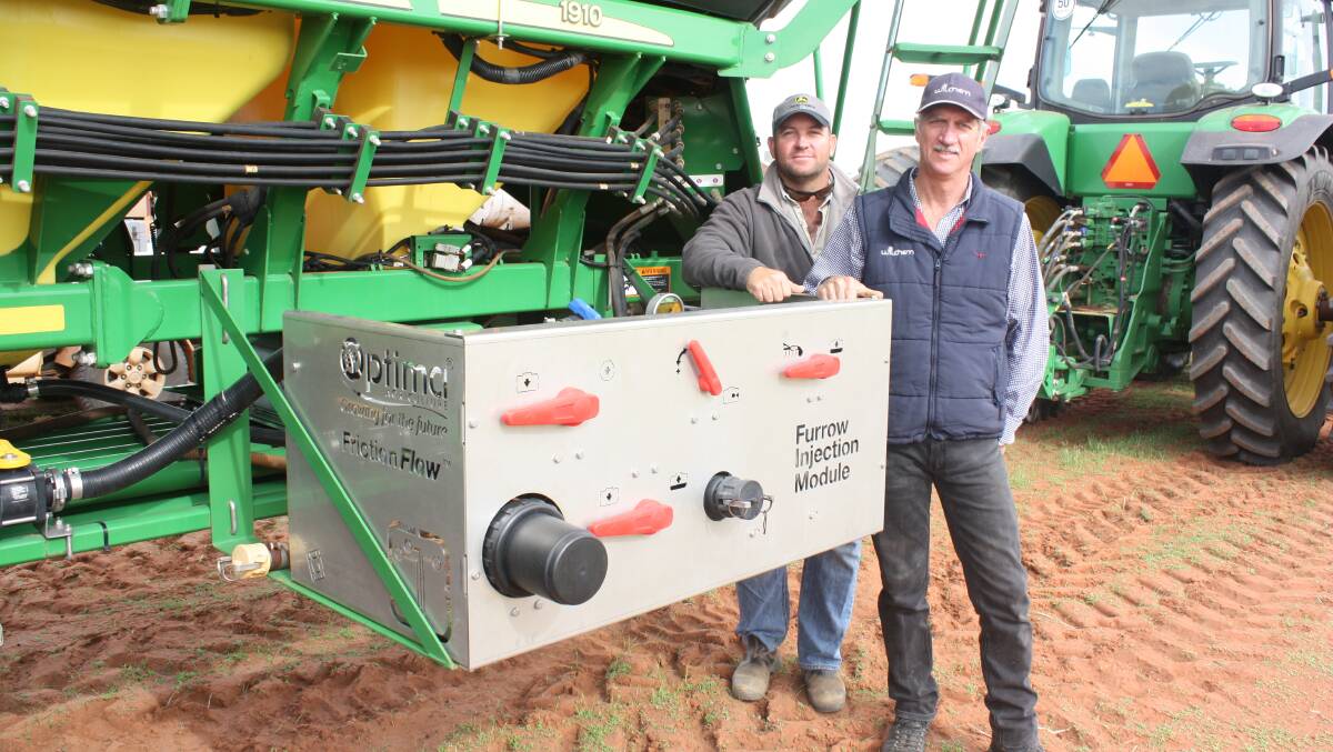 Mullewa farmer Rowley Labuschange (left) and Wilchem agronomist and trial researcher Burt Naude next to the Furrow Management Systems Friction Flow liquid injection system.