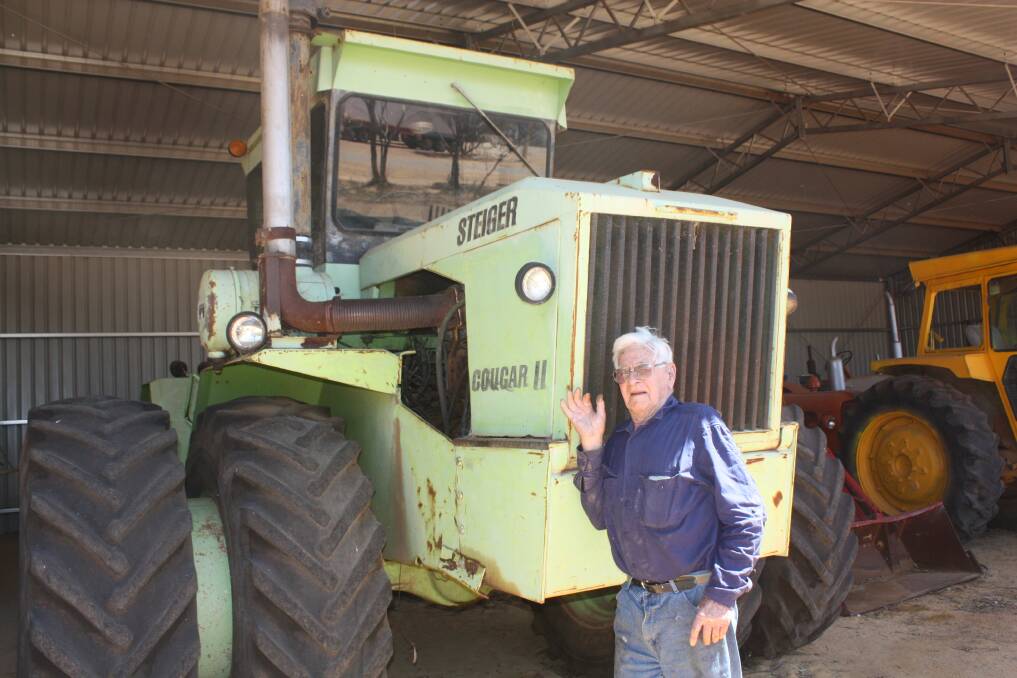 Beacon's Men's Shed curator Bruce Ingleton in front of a Steiger Cougar II. It was donated last year by former Beacon Steiger machinery dealer Bob Adshead. At one time, Mr Adshead was Australia's biggest Steiger dealer and Mr Ingleton hopes it will be fully restored to its former glory.