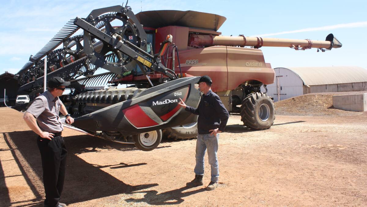 Purcher International salesman Gerard Williamson (left) and Tenindewa farmer Glenn Thomas talk about the performance of the MacDon D140 draper on Glen's two new 8250 headers, which fired up last week in a canola program and will be into cereals this week.
