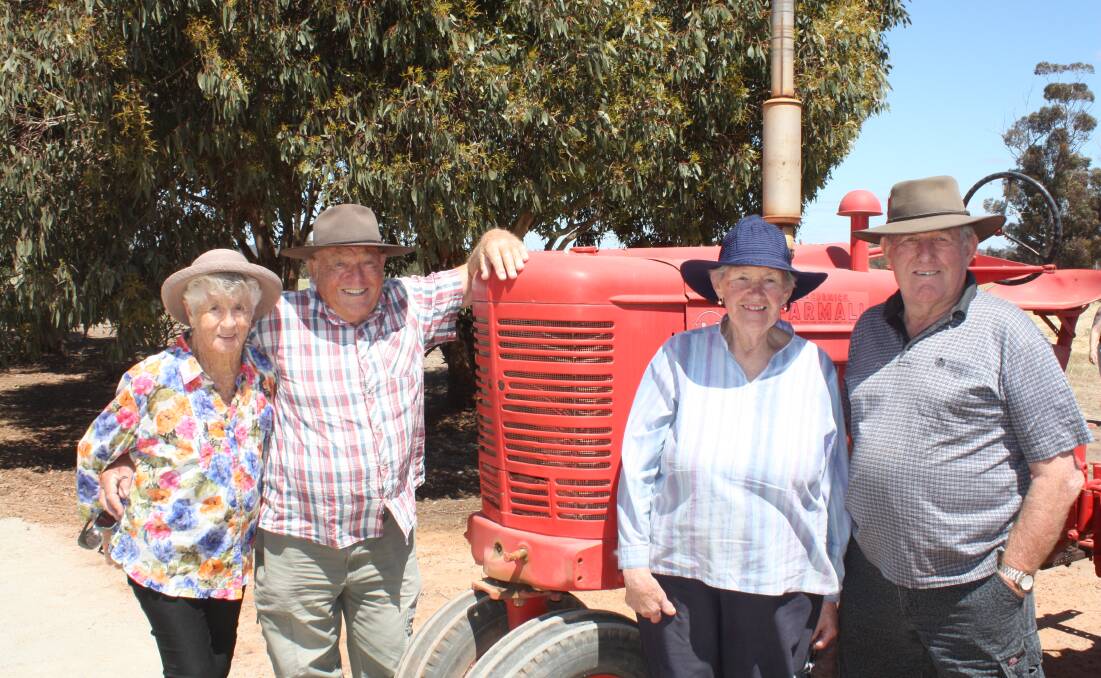 Admiring the Farmall M tractor were, from left, Ross and Verrell Pederson, Bridgetown and Gerald and Marjorie, Richings, Bridgetown. "I used to drive the H model in my time," Ross said.