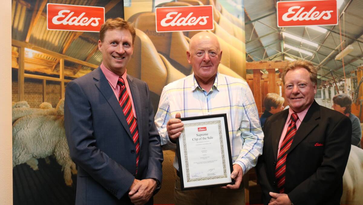 Elders zone general manager-west, James Cornish (left) and Elders wool sales manager Tim Burgess (right), congratulate John Rutherford, Duranillin, on his family winning the Supreme Clip of the Sale award for sale F36.