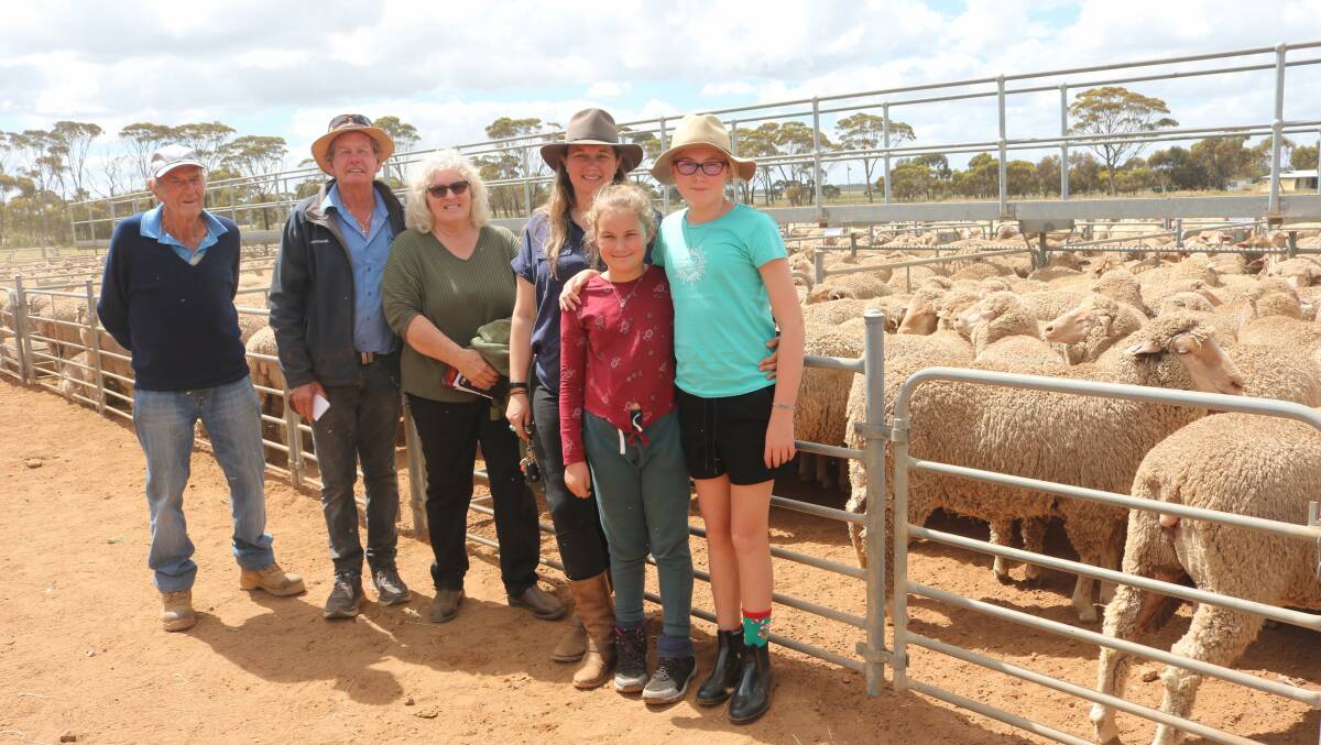  Vendor Vern Brown (left), VS & J Brown, Hyden, proudly stands beside Westcoast Wool & Livestock Kulin agent Barry Gangell, after selling his pen of 214 1.5yo Merino ewes for a sale top of $282 when Marion Price, Prices Contracting, Jitarning, pursued the line. With them is Marion's daughter Alicen Johnson and her granddaughters Ebony (9) and Kacey (12) Johnson, Mandurah.