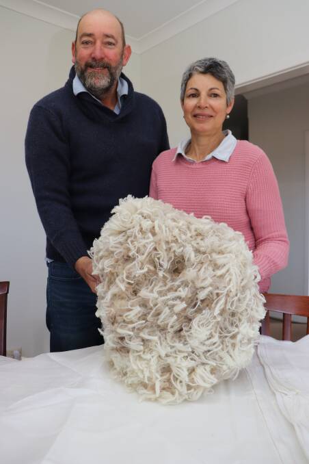 Murray and Julie Ayers, Salmon Gums, with a fleece off a white tag ewe hogget shorn recently. The Ayers family have made a significant investment in their Merino flock in the past few years and Murray said this was showing in the consistency of fleeces he was seeing come through.