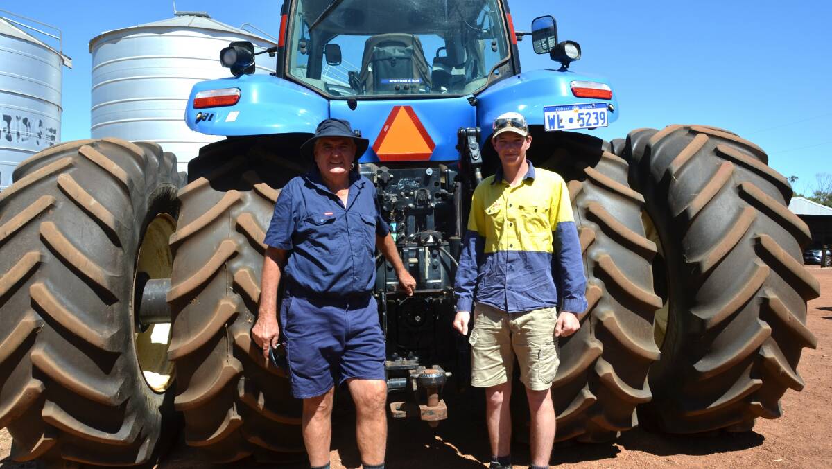  Vendor Kennedy Hogg (left) and Daniel Fisher, Ongerup, with the tidy 2013 New Holland T8.330 front-wheel-assist tractor that was top sale item at $145,000.