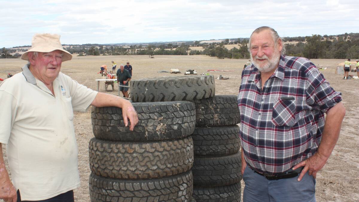 Retired Kojonup farmers Graeme Hobbs (left) and Peter Jones pictured next to 11 tyres in fair condition for farm work. They were snapped up for $30.