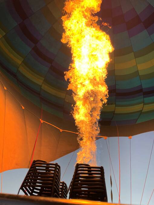 A gas burner blast to add more heat to the air in the balloon to keep it aloft.