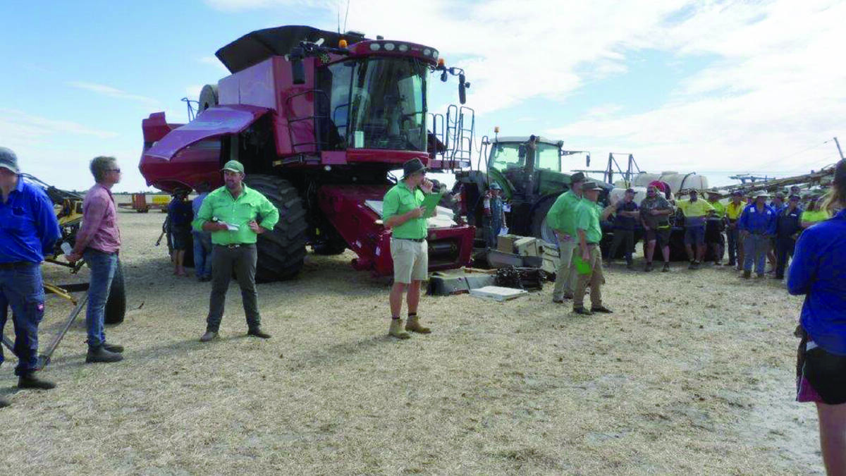 The Nutrien Livestock selling team led by auctioneer Neil Brindley (right) selling the Case IH 8010 harvester on offer which sold for $100,000 in the sale.