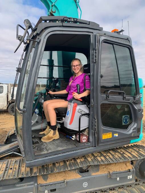 Machine operator Ines Kuett in the new excavator a $100,000 Regional Economic Development grant from the State government via the Wheatbelt Development Commission, helped purchase.
