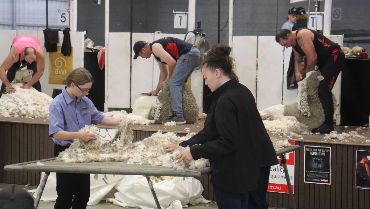 Students skirting the fleeces during the AWI Future Sheep Breeders competition at the Perth Royal Show.