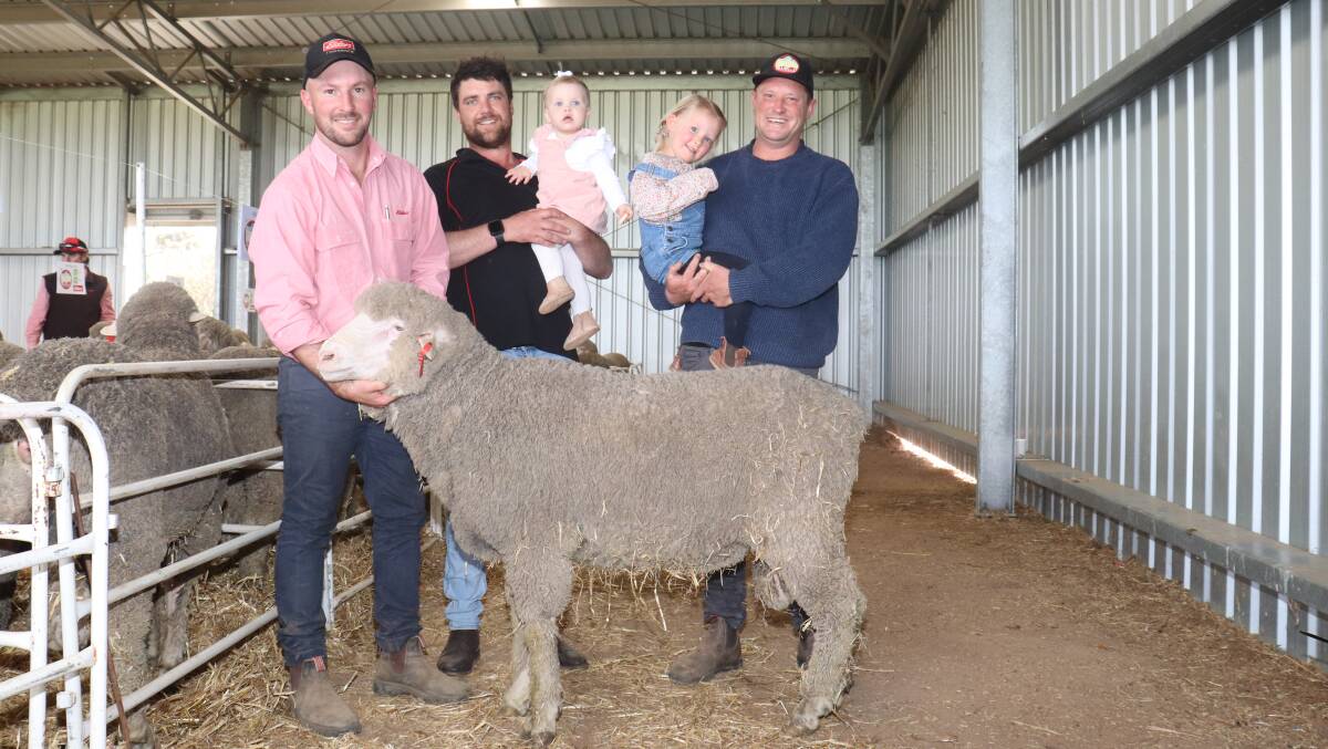 Holding the $3400 top-priced ram purchased by Lachlan Lewis, Pallinup River Stud Farm, Gnowangerup, was Elders Gnowangerup agent James Culleton (left), with Josh Leppens holding daughter Billie, Mianelup stud and Mianelup stud principal Elliot Richardson (right) holding daughter Celeste.