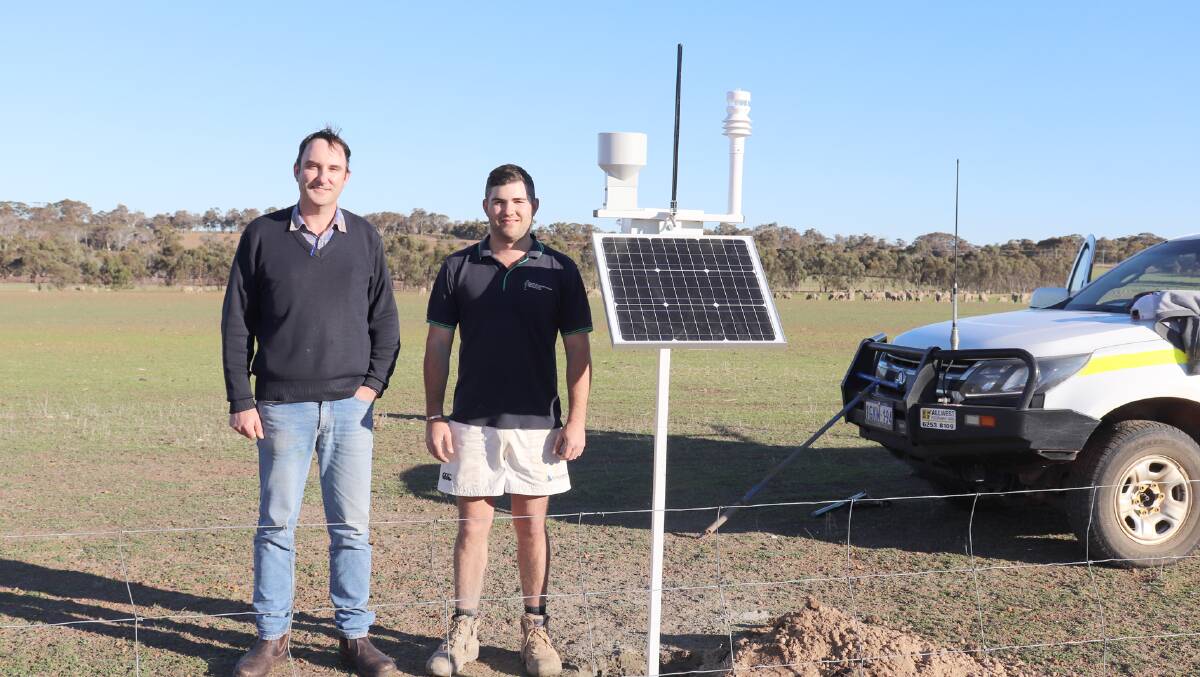 Department of Primary Industries and Regional Development research officer John Paul Collins (left) with Goanna Ag contractor Sam Long at the new weather station and rain gauge at the DPIRD Katanning Research Facility which will host day two of this years Southern Dirt TECHSPO. A soil moisture probe was also installed behind them.
