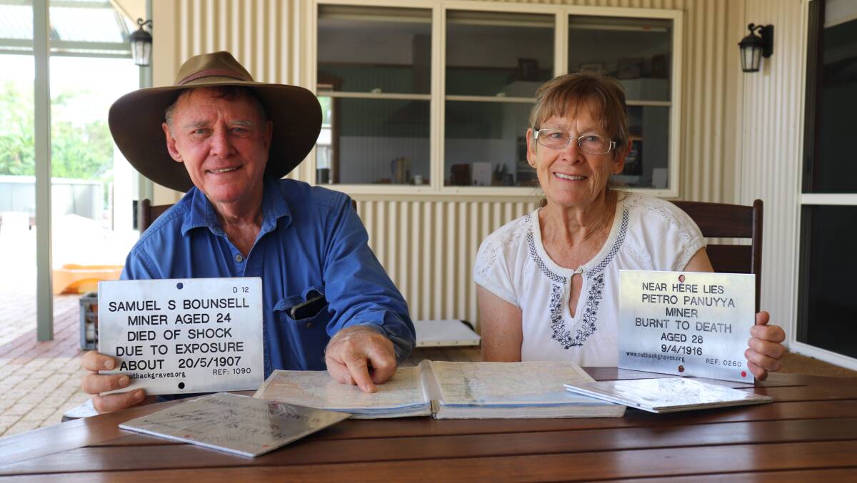 Co-founder of Outback Grave Markers Trevor Tough and wife Sue with map book and some of the engraved plaques to be placed on graves in the bush and remote cemeteries on their next trip into regional WA.