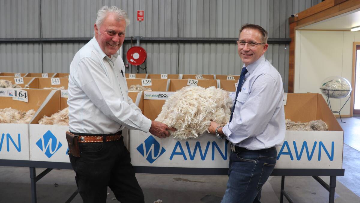 Happy Sheeps woolgrower Stephen Sprigg (left), Wialki, with a sample of his wool and AWN State wool and livestock manager Greg Tilbrook.