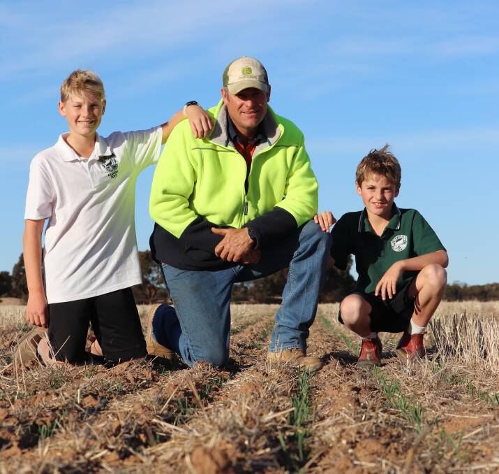 Hyden farmer Frank Nield inspects a crop of Spartacus barley with his sons Alastair (left) and Darcy. An 11 millimetre rain event over the weekend will help keep this crop ticking along, but Frank said he was hoping for a 30-40mm rain event soon to replenish soil moisture.