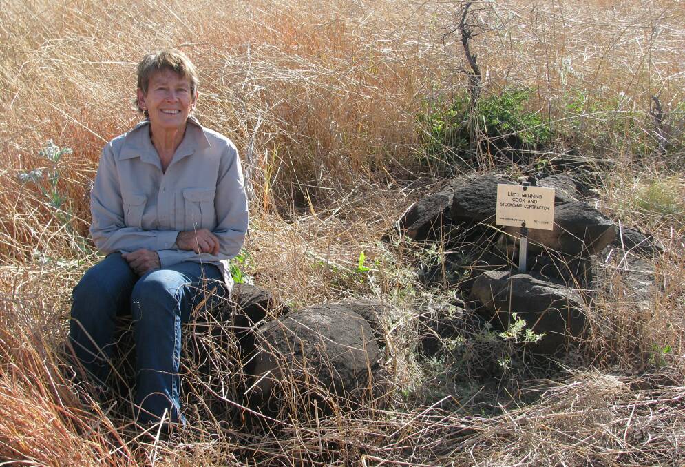 Sue Tough beside the pile of rocks and just-placed plaque marking the previously lost grave of stock camp cook Lucy Benning. The grave was located near Old Mount Hart station homestead in the West Kimberley and involved a four-hour return walk through tall grass to get to it.