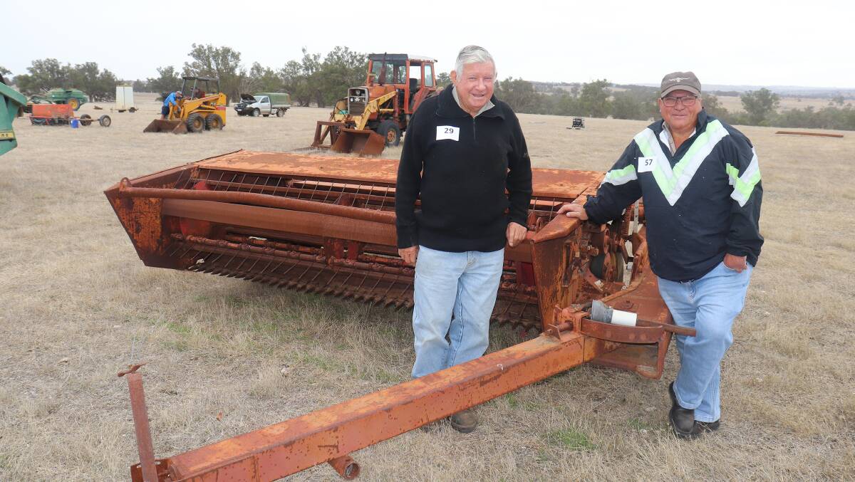 Fred Rowe (left) and Giovanni Leusciatti, both from Kojonup, with an old square baler that later sold for $2000.