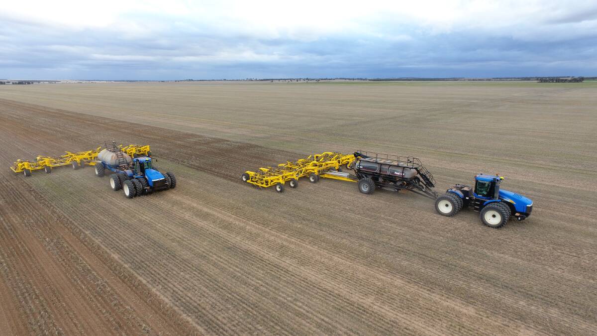 Two New Holland tractors pulling the recently delivered Seed Storm bars side by side behind the seeding carts during seeding at Nungarin last week. 