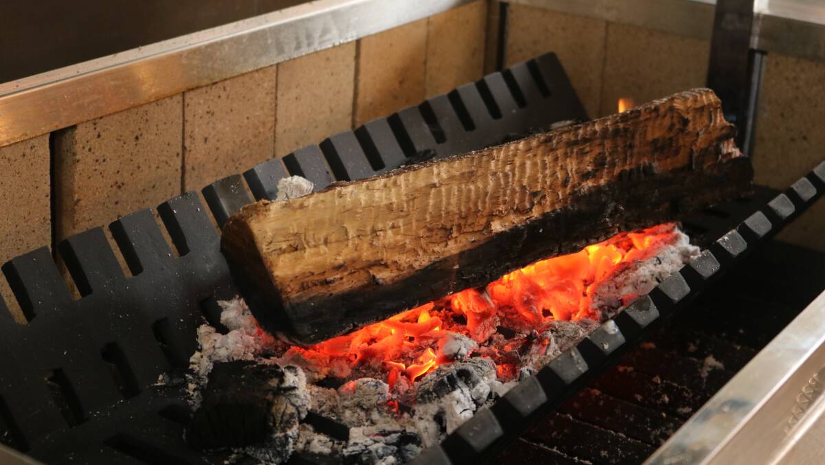 The wood-fired grill getting started in the kitchen at Oscars.