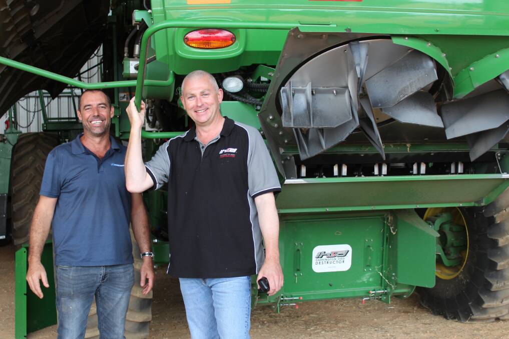 de Bruin Engineering product support manager Andrew Vearing (right), with Johnny Inferrera, McIntosh Distribution, inspecting a Harrington Seed Destructor on a John Deere header. Mr Vearing said it was critical for growers to take time in setting up their harvesters to suit their region, the environment, their particular crop types, and the condition of their crops.