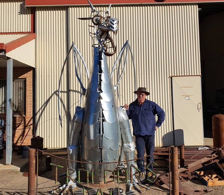 Artist Peter James at his Metal Art Creations workshop in Dongara. He is standing next to a Dragon Sculpture he hopes to enter in the Castaway art competition held on the Rockingham foreshore.
