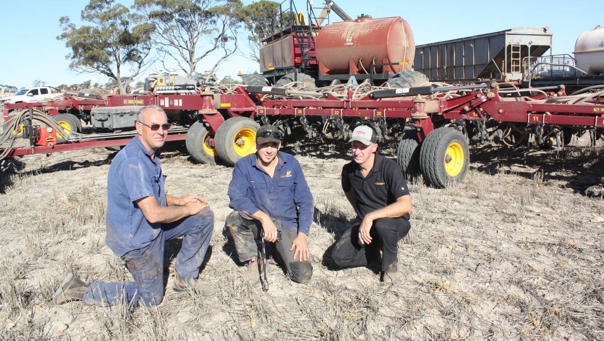 Bindi Bindi farmers Mark Graham (left) and his son Jason with Seed Hawk product specialist Russell McCagh discussing the performance of a new 18.2 metre Seed Hawk and 660 Air Cart after the completion of a 3000-hectare sowing program.