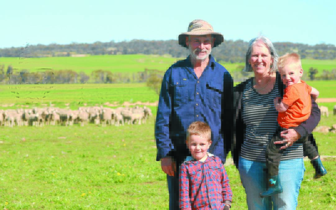  Pingelly prime lamb producers David (left) and Sheryl Squiers, with their grandsons Ned (2) and Sonny Squiers (4) check out their F1 Poll Dorset-Merino lambs.