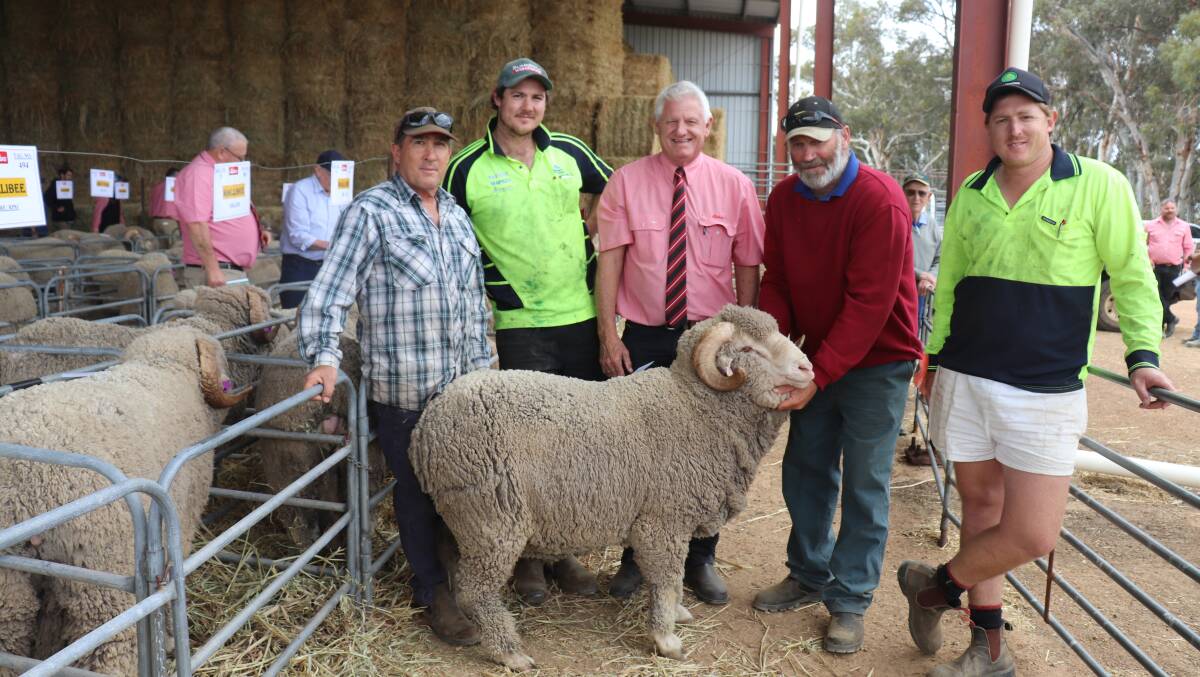 Greg Cocking (left), EH & BH Cocking, Wannamal, and sons Scott (second left) and Mitchell (right) bought one ram at the Mallibee Merino & Poll Merino ram sale the top-priced Merino at $2200. With them are Elders auctioneer Deane Allen and stud co-principal Roger Glover holding the ram.