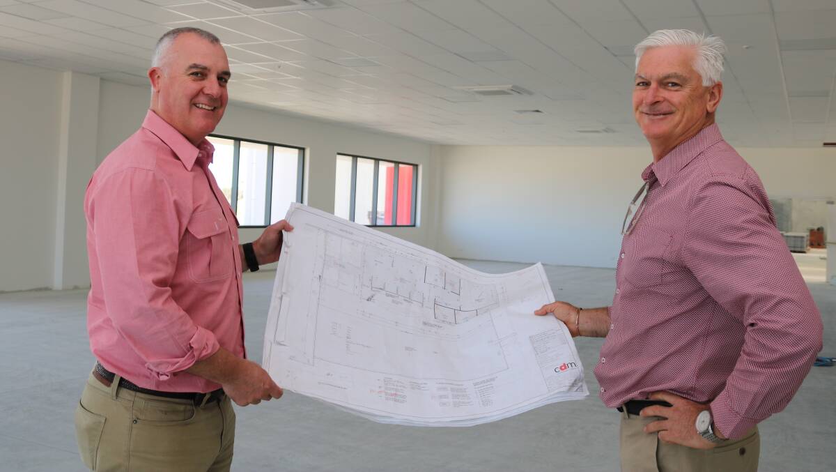 Elders State general manager Nick Fazekas (left), looks over plans for the new Elders Muchea branch with Lester Group director Adrian Lester.