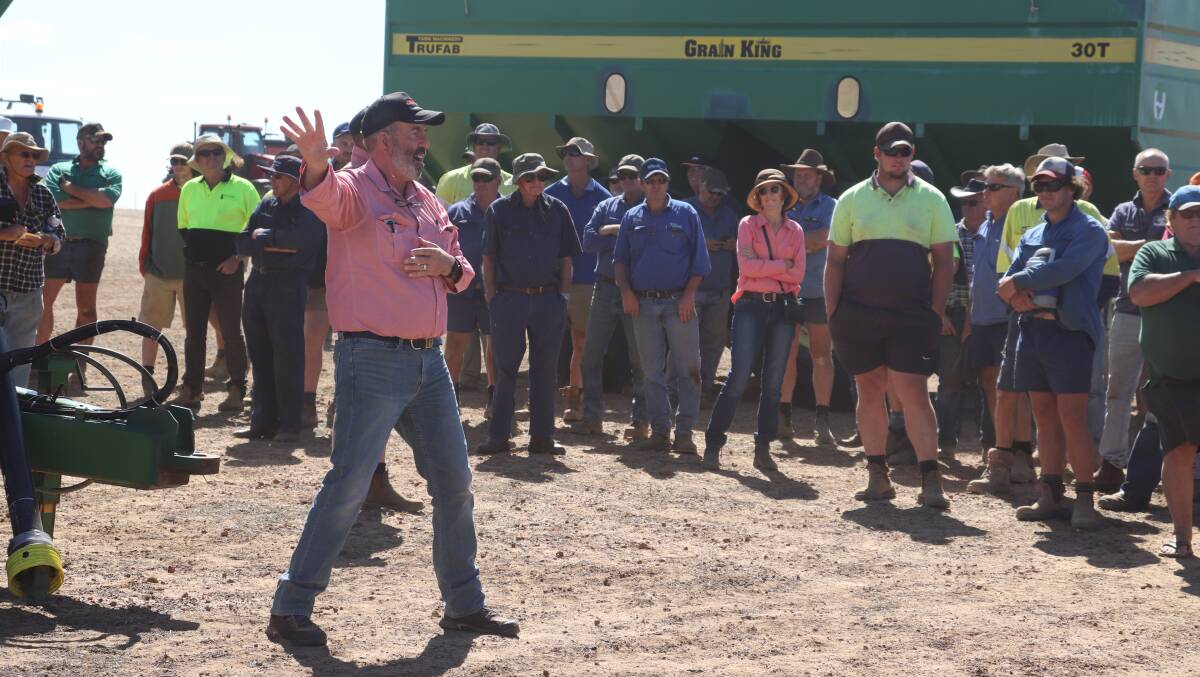 Elders auctioneer Dean Hubbard in full swing last week at the EDL Farms clearing sale at Lake Magenta, Newdegate. The Trufab Grain King 30t chaser bin behind the crowd sold for $36,000, while a 25t one sold for $23,000.