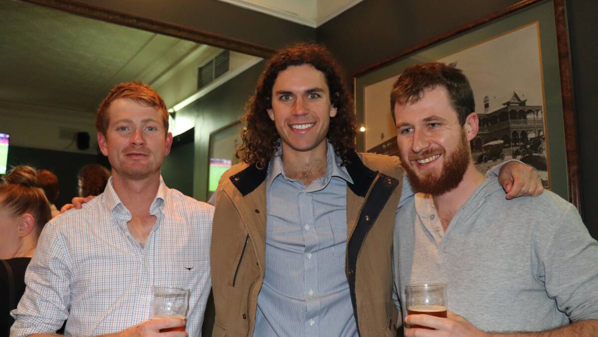  Curtin University student's Ben Taylor (left) and Spencer Beatty, with livestock employee Joel Carmody.