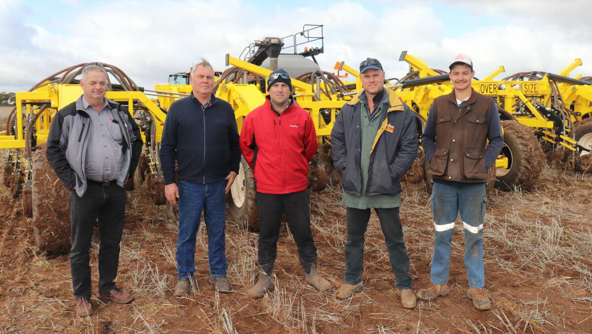 Shayne Smith (second right), with Duraquip director Garry Robinson (left), Gnowangerup, Shayne's father and brother Ken and Lee Smith and Jai de Lacy, Nungarin, in front of a new Seed Storm 18-250 air drill seeder bar at one of its first demonstrations last June during a McIntosh & Son, Merredin, machinery field day on the de Lacy property.
