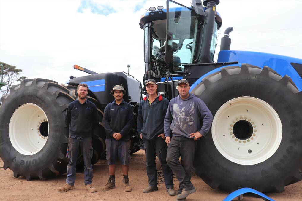 Brothers Shayne and Lee Smith (right), Dongolocking, with the new tractor they have waited 12 months for and McIntosh & Son, Katanning, technician Isaac Sugg (left) and first-year trainee Ronan Bouquet.