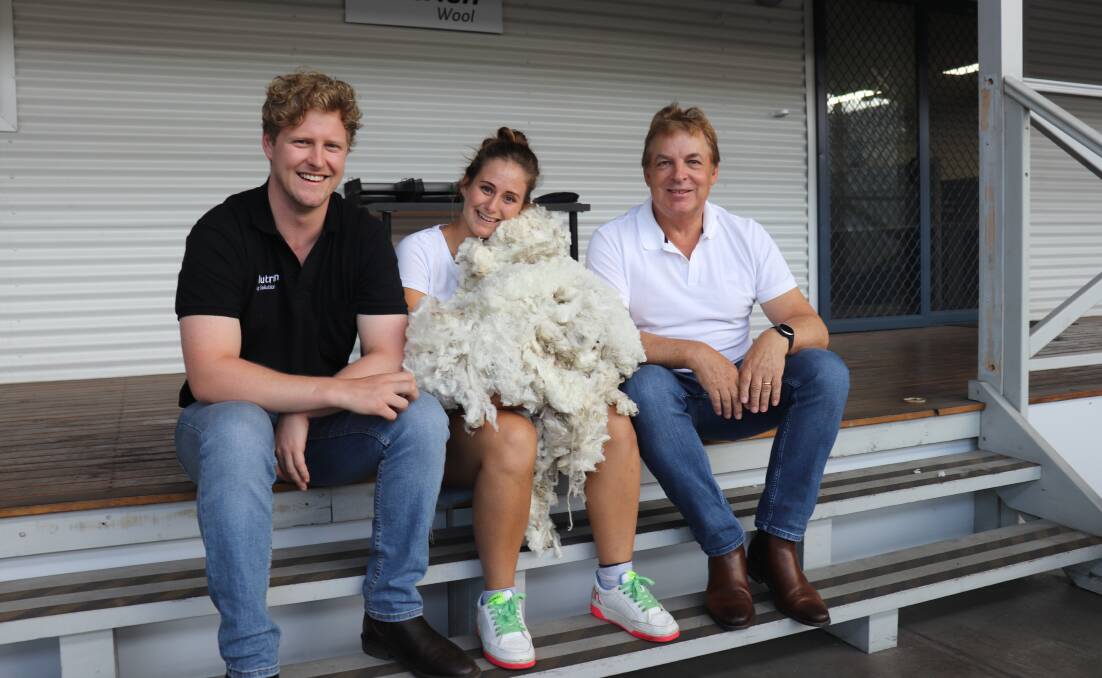Nutrien Ag Solution's Rohan Gaunt (left), Fremantle Wool Trader's wool valuer Martina Delorenzi with a sample of the 14.4 micron Superfine fleece she identified in the Nutrien wool catalogue and Fremantle Wool Trading director John Bradbury.