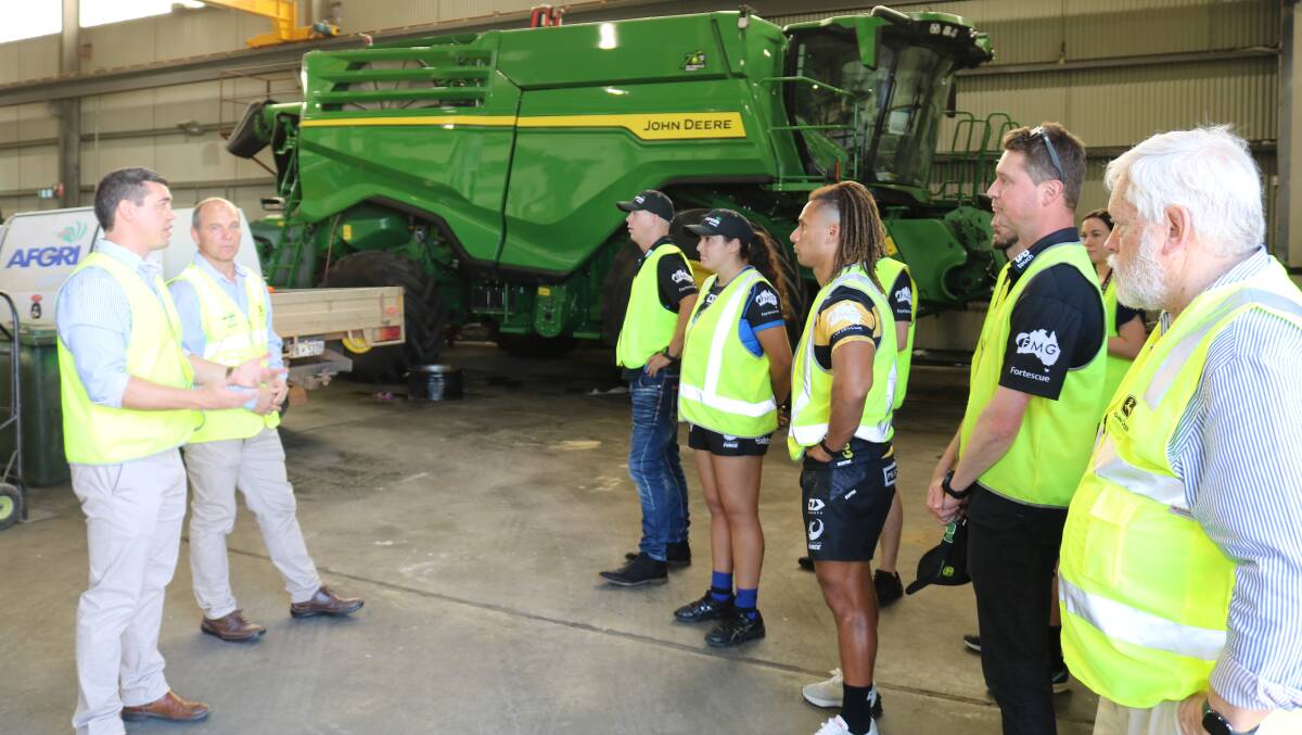 AFGRI Equipment general manager sales and marketing Jacques Coetzee (left) and commercial director Wessel Oosthuizen took Western Force players and staff for a tour through the companys South Guildford workshop where a latest model John Deere X9 header was being commissioned.
