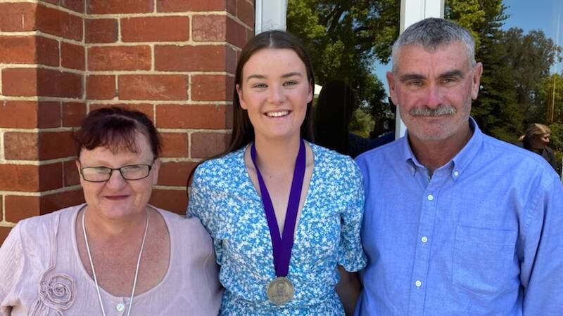 Kate and Stefan Crossen with their daughter Charlotte (centre) at the presentation of her Beazley Medal in December 2021.