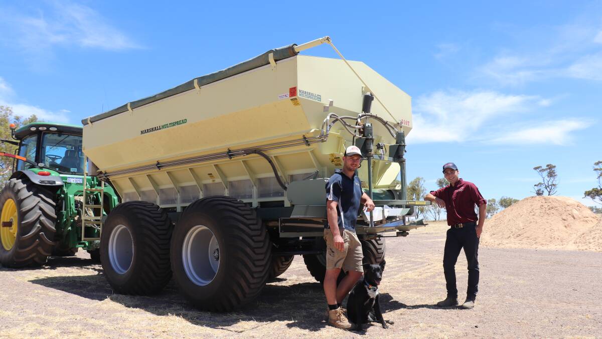Miling farmer Sam Reynolds (left) with Black Betty the dog and Lyndon Zetovic from Boekeman Machinery at the business end of the Marshall 916T Multispread Mr Reynolds is using to spread 2300 tonnes of lime sand.
