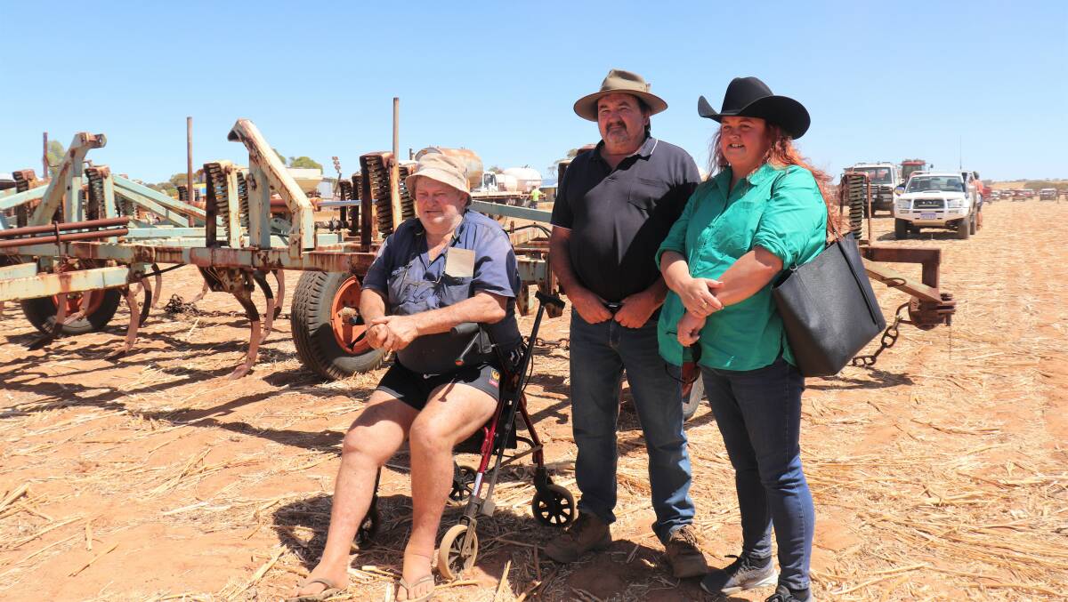 Dave Ure (left), Goodlands, with Evan and Samantha Lester, Toodyay, in front of a 10.9 metre Argroplow deep ripper Mr Ure later bought. With several people chasing the deep ripper and bidding at $10,500, he triumphed with a successful single bid of $20,000.