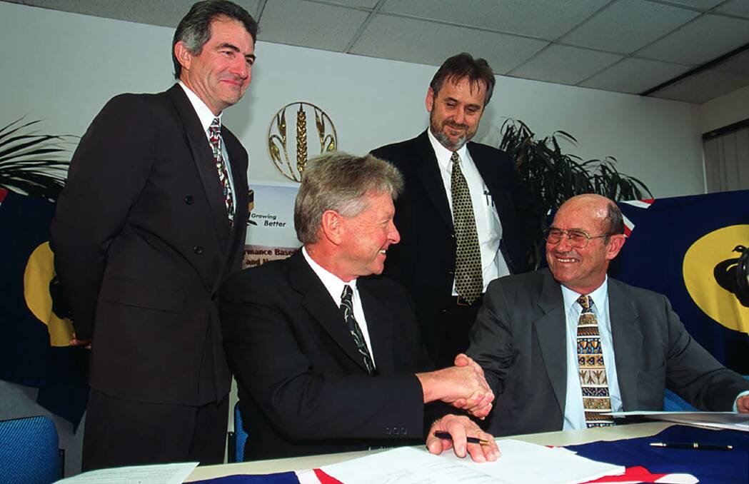 The Grain Pool merged with CBH Group in 2002. At the merger signing were Grain Pool chief executive officer Peter Reading (left) and chairman Rob Sewell, as well as CBH chief executive officer Imre Menchshelyi and chairman Allan Watson.