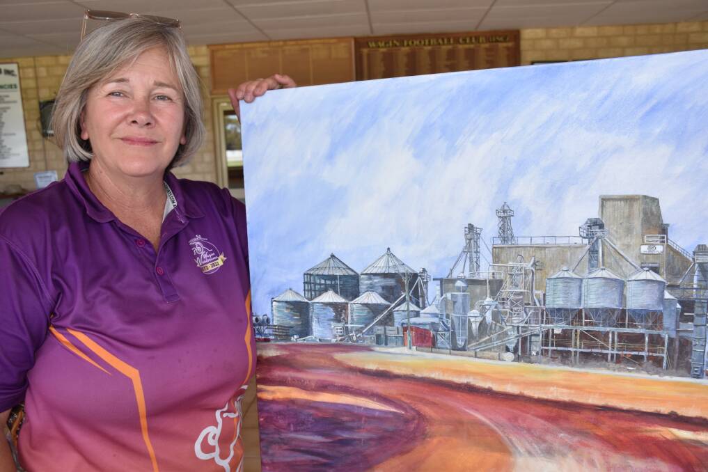 Art section head steward Fiona Dawson holding the 2021 Wagin Woolorama Art Prize winner, now part of the Wagin shires art collection. It was painted by Dumbleyung artist Kerry Scally, who snapped a photograph of the Unigrain seed works on her way to Wagin.