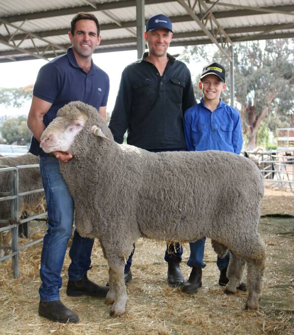  This $4800 giant of a ram held by Navanvale stud co-principal Mitchell Hogg (left), Williams, put his hand up to be in the photo with new owners Sheldon and his son Nate Kowald, Capemont Farms, Katanning. Capemont also paid the day's top price of $5000 for its polled half-brother.