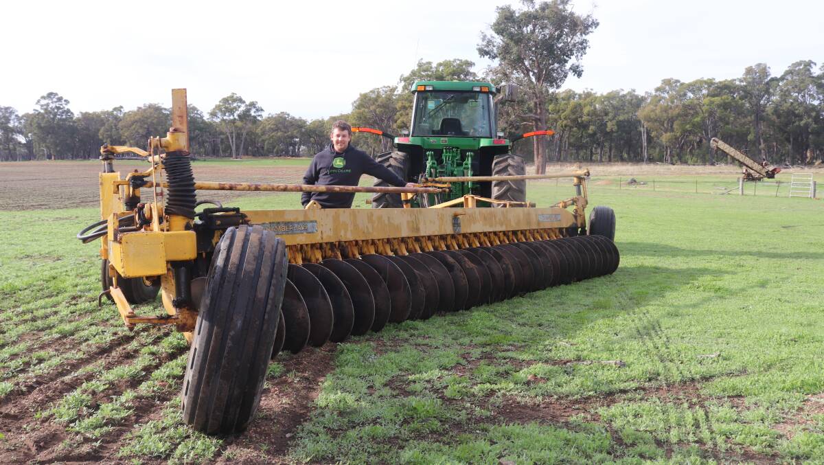  Michael Graham with the 30-disc one-way Chamberlain plough he used to prepare the ground for his first cropping program. No guidance systems other than looking over your shoulder to check the plough line is straight.