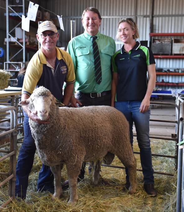 Buyer Tim Adams, Kukerin, holds the $3700 top price ram at Monday's Chirniminup Dohne ram sale at Nyabing. With him is Roy Addis from Nutrien Livestock Breeding representative and stud principal Rachel Browne.