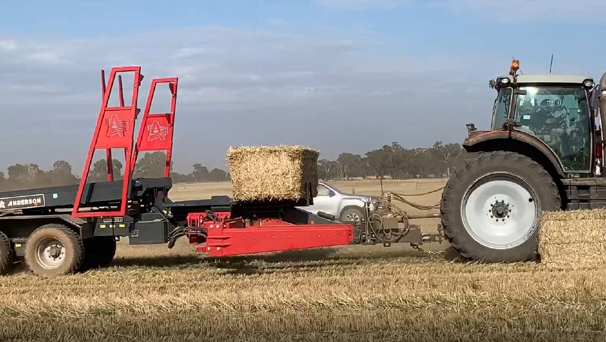 The Anderson Stackpro in action showing the heavy duty clamp which lifts a large square baler onto the trailer.