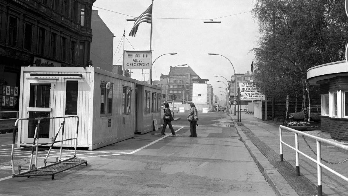 A 1970s picture of Checkpoint Charlie in the Berlin Wall with the Allied end of the 'Cold War' crossing point between East and West closest and the East German end with the prominent machinegun tower in the distance. John Kirkpatrick crossed here to sell WA wool in East Germany