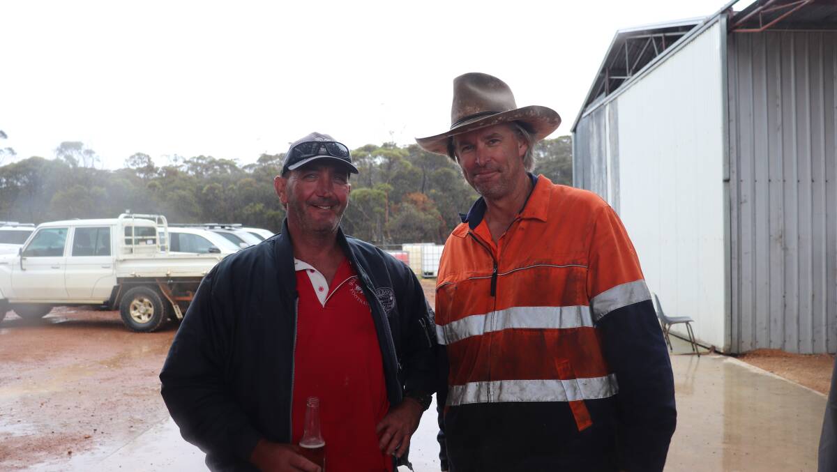 Bremer Bay farmers Stuart Gillespie (left) and Peter Buckenara enjoying a catch up over a cold drink as the rain came down.