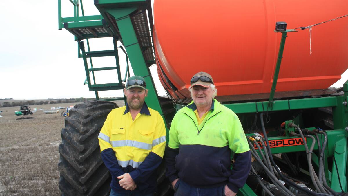 Borden farmers Tim Schlueter (left) and Jim Macaulay, next to a Ausplow M18000 Multistream air seeder and DBS D300-61 precision seeder with hydraulic steering which later sold for the sale second top price of $340,000.