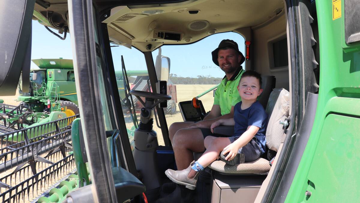 Enthusiastic little farmer Hugo in one of 'his' headers with dad Bevan McDougall.