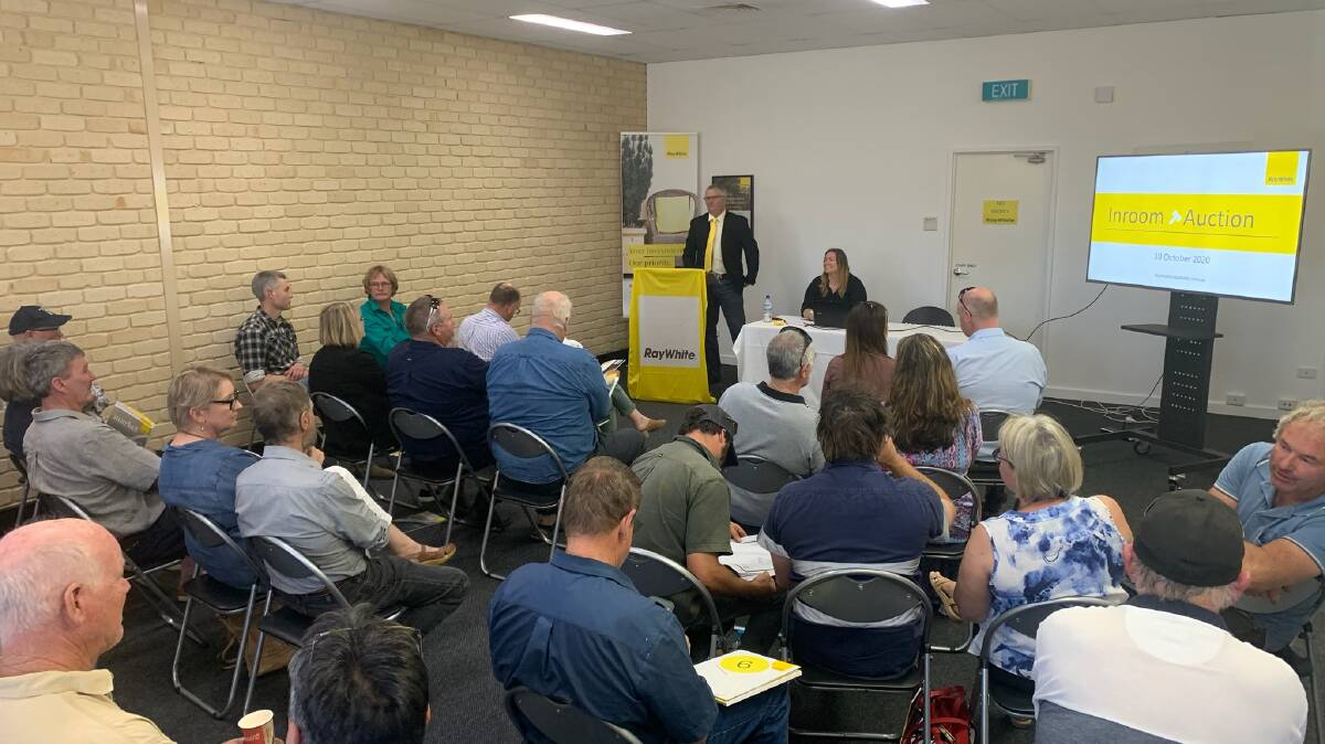 At the podium and ready to kick off proceedings, Ray White Rural Albany principal and auctioneer John Hetherington sold South Kaybellup Farm and Takenup Tree Farm in separate auctions to local but different buyers. Photos: Ray White Rural Albany.