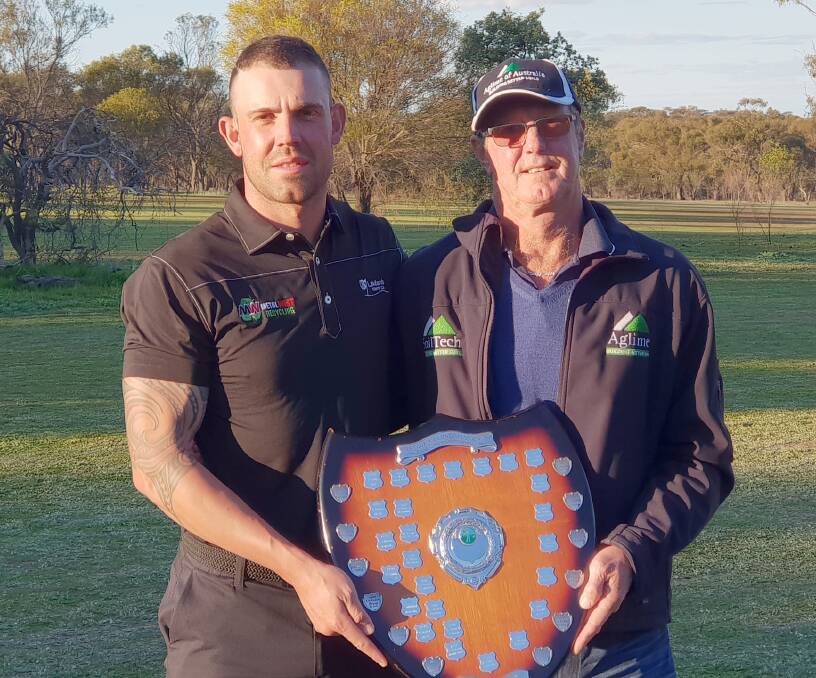 Ryan Peake (left), Lakelands Country Club, accepts the 2019 Aglime of Australia Sand Greens Championship of WA trophy from Dave Gartner, of Aglime of Australia.
